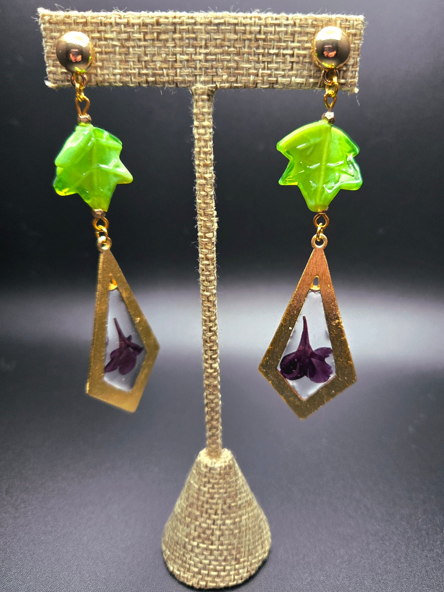 Dangle earrings with green glass bead.