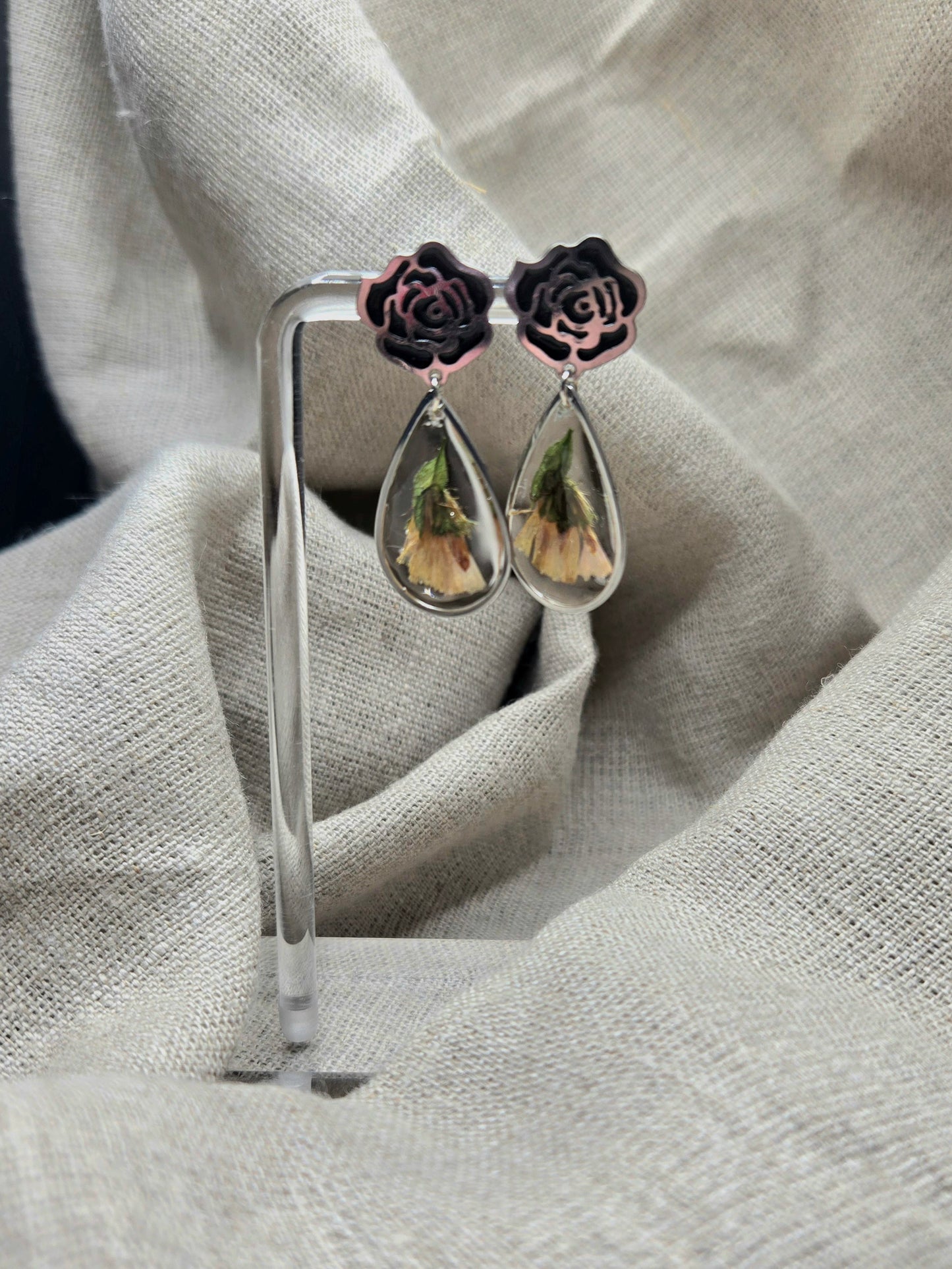 Teardrop earrings in silver tones with black enamel rose