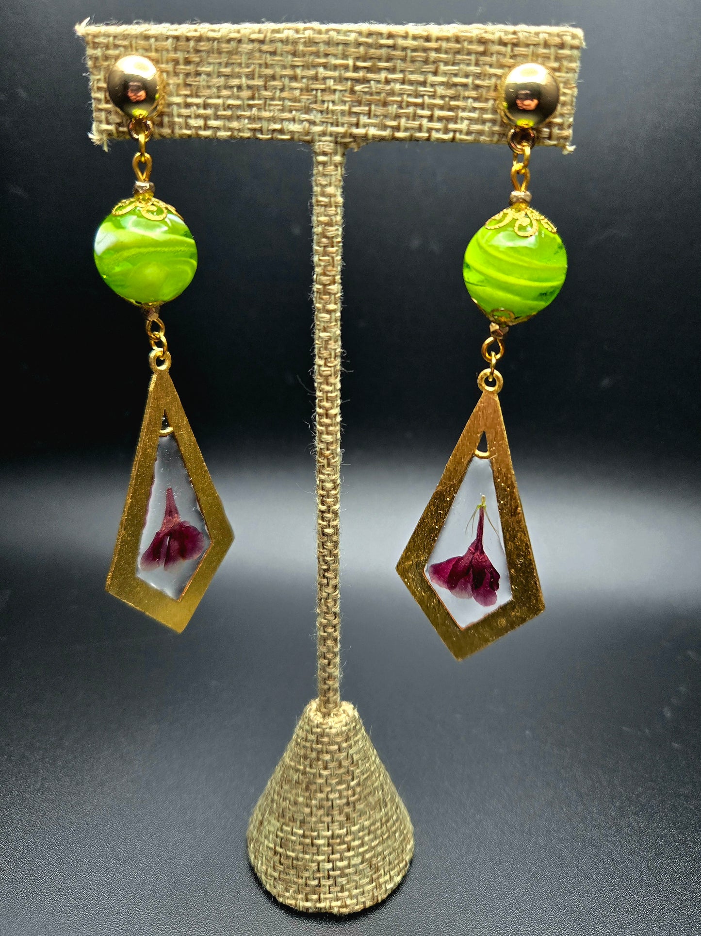 Dangle earrings with green glass bead.