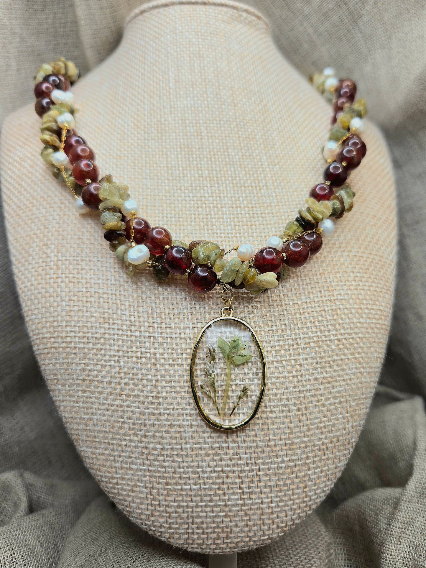 Red and green twisted necklace with floral pendant