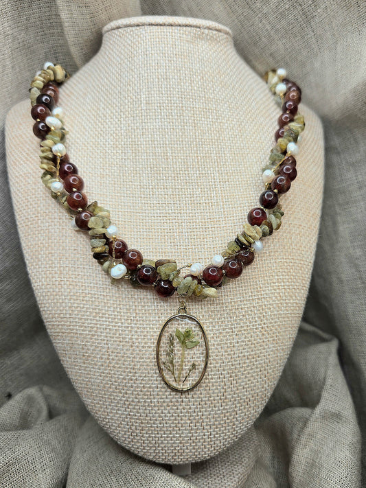 Red and green twisted necklace with floral pendant