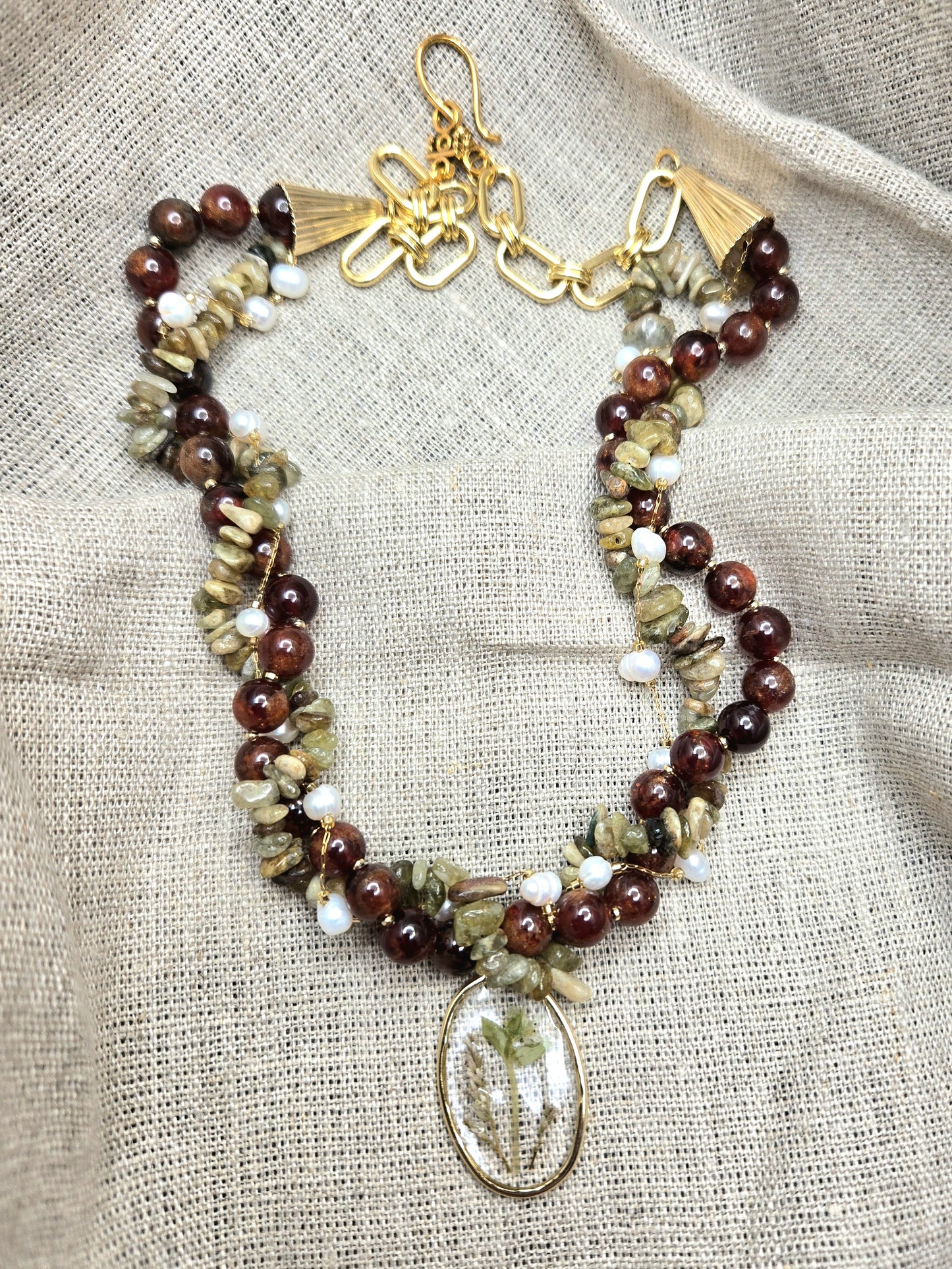 Red and green twisted necklace with floral pendant